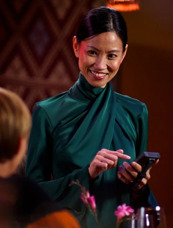 Waitress takes a guest's order at the table using a mobile device.