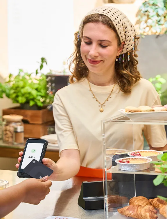 Small business owner accepting a contactless card payment