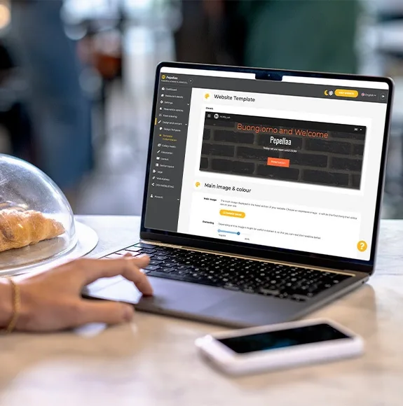 Close-up of a laptop with a restaurant website with a digital menu open.